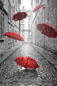 Красные зонты летят по черно-белой улочке